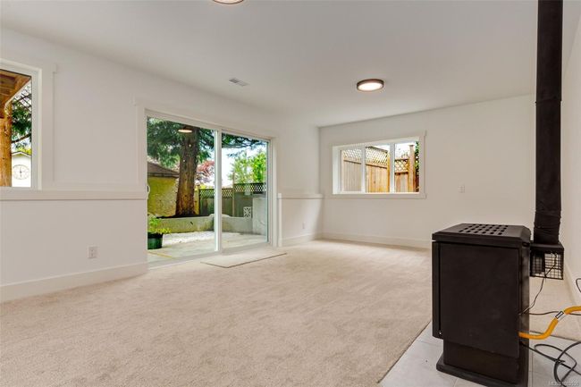 Rec room with fireplace and access to backyard patio space | Image 70