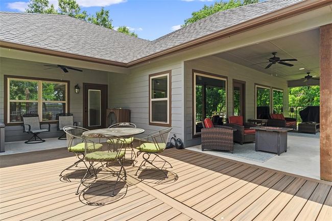 Wooden terrace with ceiling fan and outdoor lounge area | Image 25