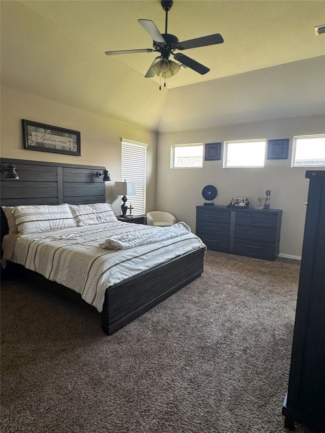 Master Bedroom with multiple windows, carpet, a ceiling fan, and lofted ceiling | Image 7