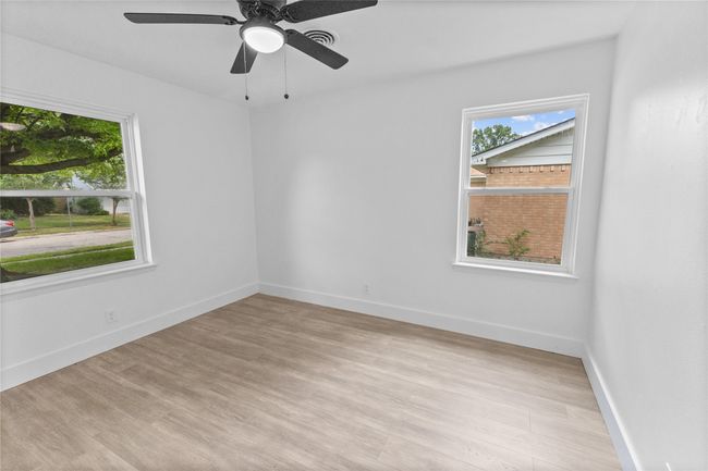 Unfurnished room featuring plenty of natural light, light wood-style flooring, ceiling fan, and baseboards | Image 24