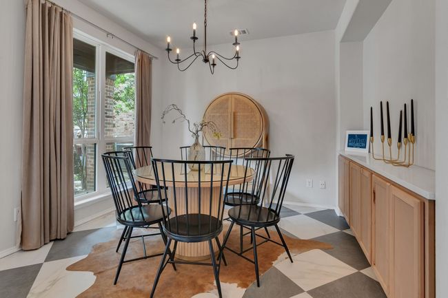 Dining space with a chandelier, healthy amount of natural light, light floors, and baseboards | Image 6