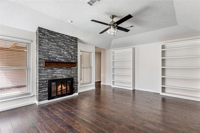 The build in cabinets can be used to show off all the family photos. | Image 7