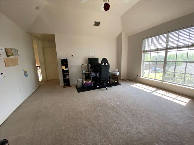 Unfurnished office featuring light colored carpet and vaulted ceiling | Image 37