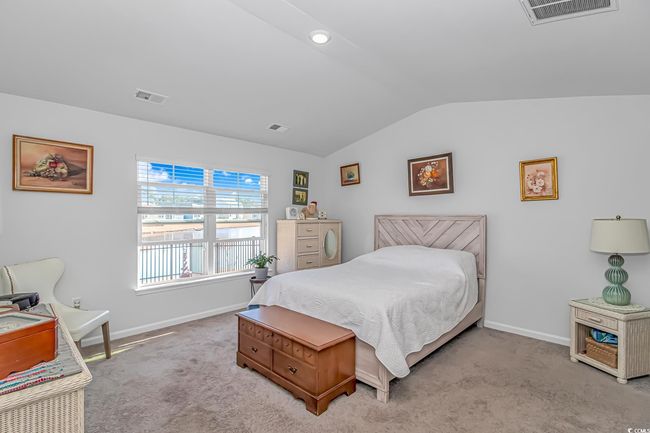 Carpeted bedroom featuring vaulted ceiling | Image 10