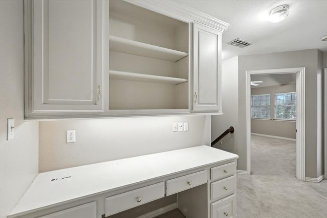 Upstairs desk/office featuring light colored carpet and baseboards | Image 23
