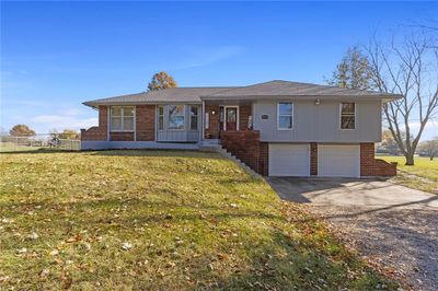 View of front of home featuring a garage and a front lawn | Image 1