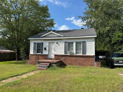 Bungalow-style house featuring cooling unit and a front yard | Image 2