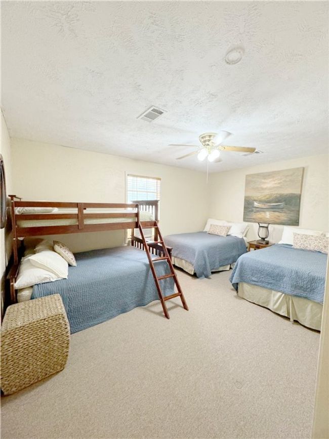Carpeted bedroom with visible vents, a textured ceiling, and ceiling fan | Image 12