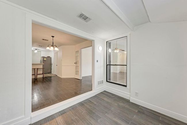 Unfurnished room featuring visible vents, baseboards, an inviting chandelier, and wood finished floors | Image 12