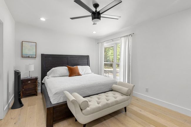 Bedroom with light wood-style floors, baseboards, and recessed lighting | Image 23