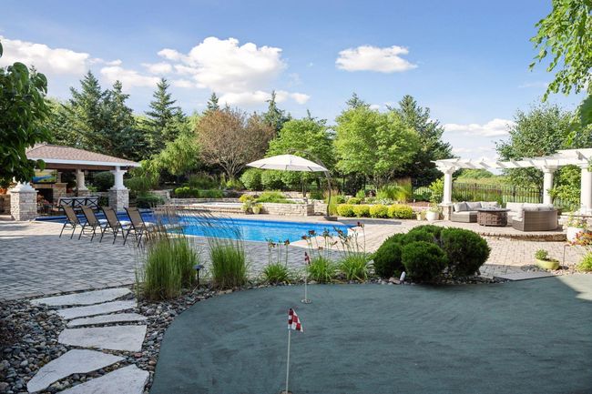 Putting green overlooking your pool and patio. | Image 78