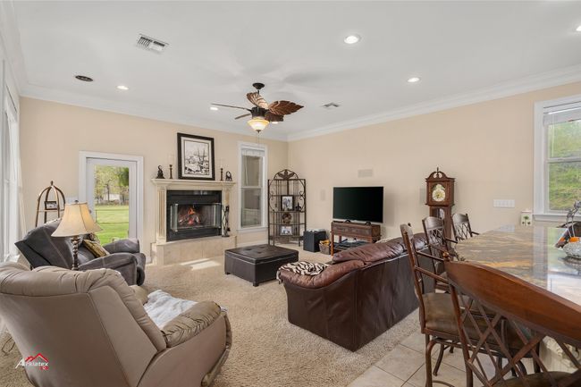 Spacious family room with fireplace. Leads to back patio. | Image 20