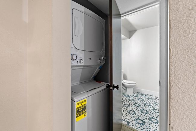 Clothes washing area featuring estacked washer and dryer | Image 24