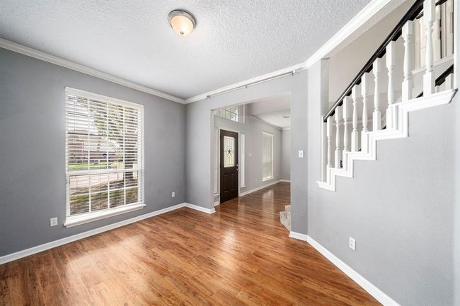 The homes entry is flanked with double formals | Image 4
