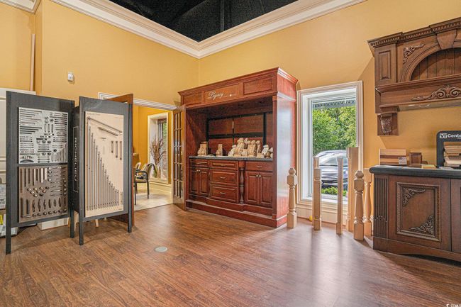 Interior space with dark wood-style flooring and crown molding | Image 5