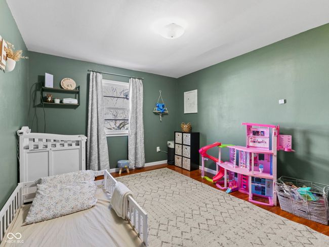 bedroom featuring baseboards and wood finished floors | Image 22