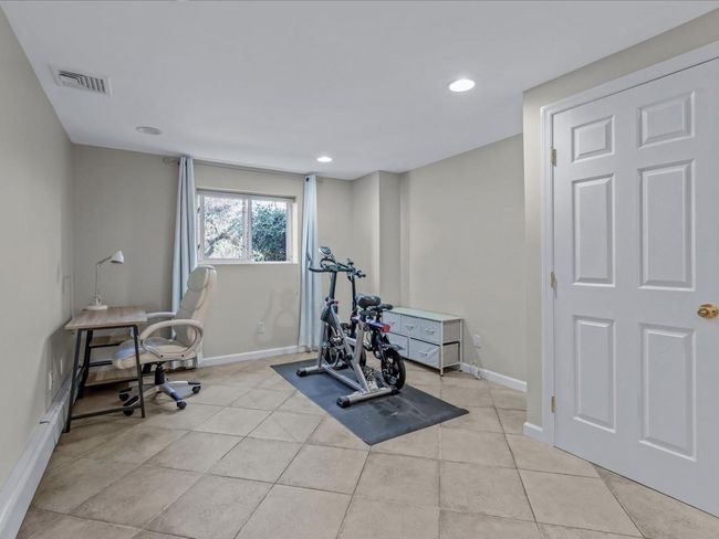 Workout room featuring light tile patterned floors, baseboards, and visible vents | Image 21