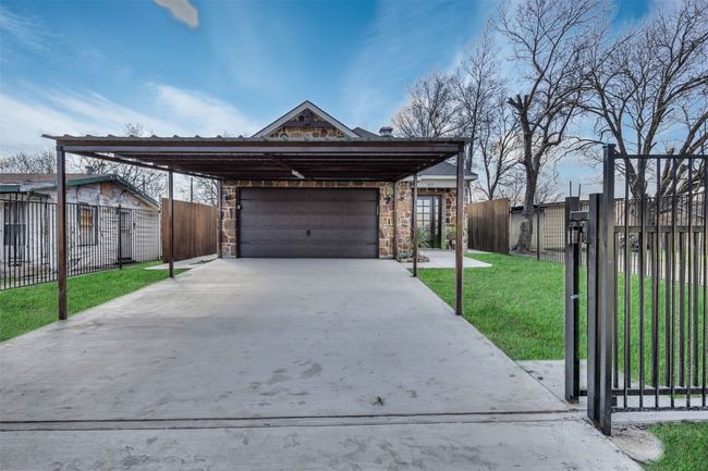 View of front of property featuring a garage, a carport, and a front yard | Image 25