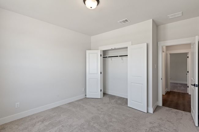 Unfurnished bedroom with carpet flooring and a closet | Image 22