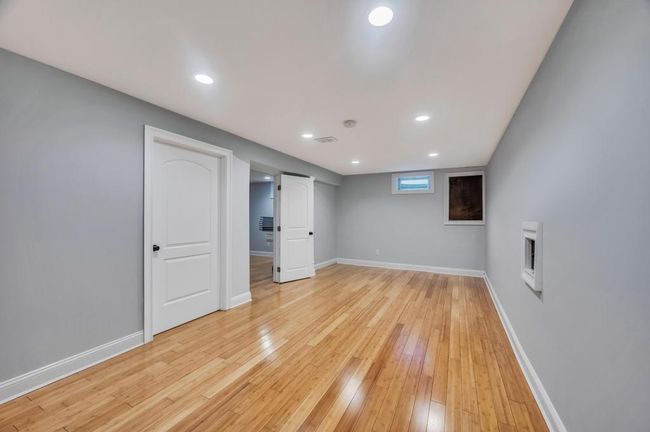 Basement featuring baseboards, light wood-type flooring, and recessed lighting | Image 20
