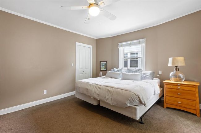 the guest bedroom with ceiling fan | Image 16