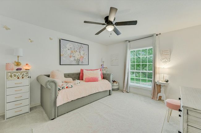 Bedroom featuring carpet flooring, baseboards, and ceiling fan | Image 22