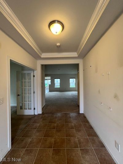 Corridor with crown molding and dark colored carpet | Image 3