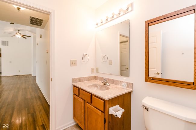 bathroom featuring wood finished floors, visible vents, ceiling fan, and toilet | Image 20