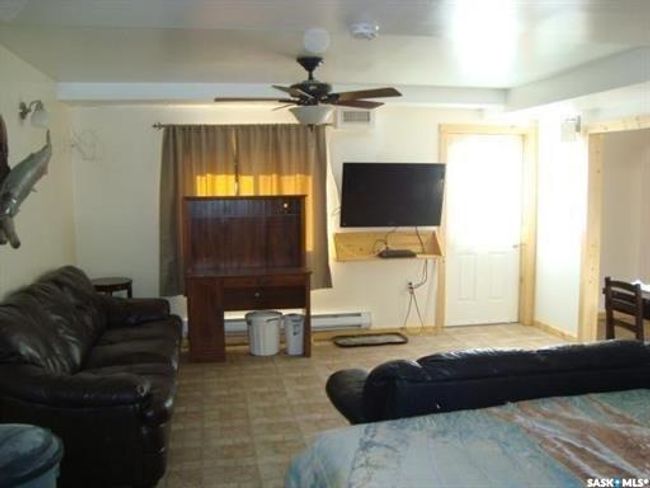 Living room with ceiling fan and a baseboard radiator | Image 44