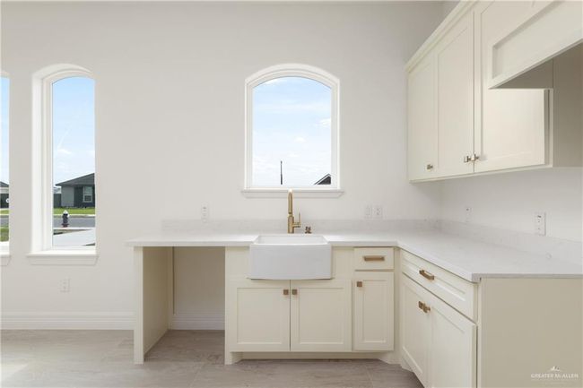 Apartment Kitchen with Premium FinishesStylish kitchenette featuring quartz countertops, gold hardware, a deep farmhouse sink, and custom cabinetry—perfect for independent living. | Image 29