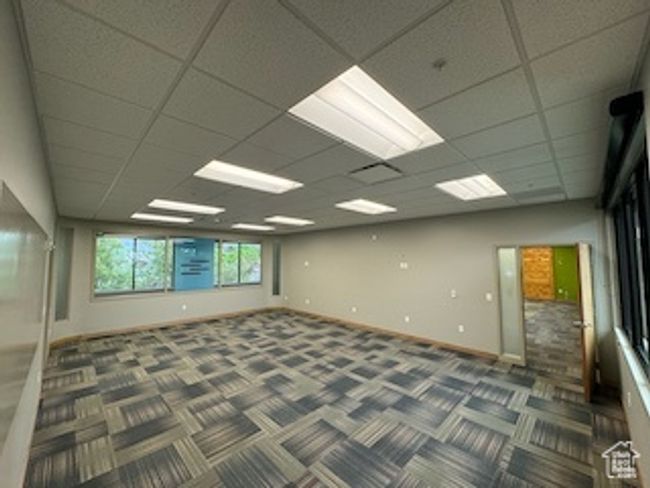 Carpeted spare room with baseboards and a paneled ceiling | Image 13