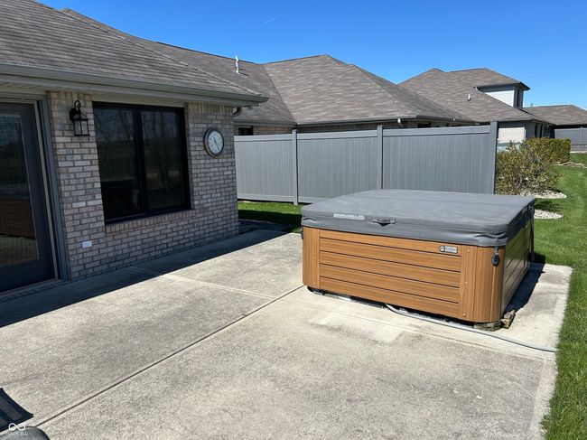 view of patio / terrace featuring fence and a hot tub | Image 22