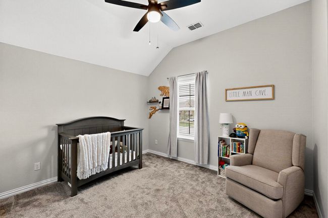 Bedroom with a nursery area, carpet flooring, vaulted ceiling, and a ceiling fan | Image 26