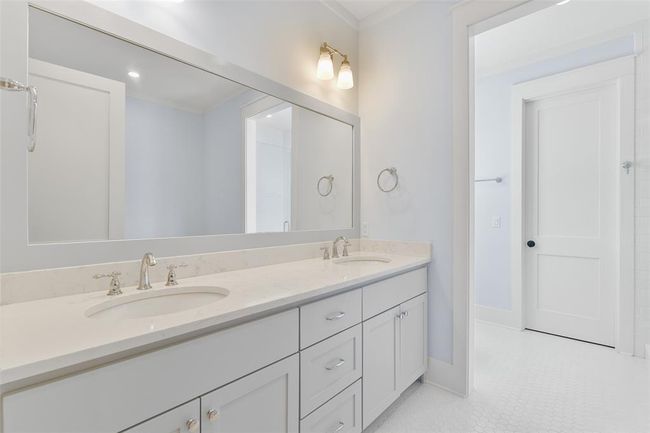 Primary bathroom offers a large double sink vanity. | Image 27