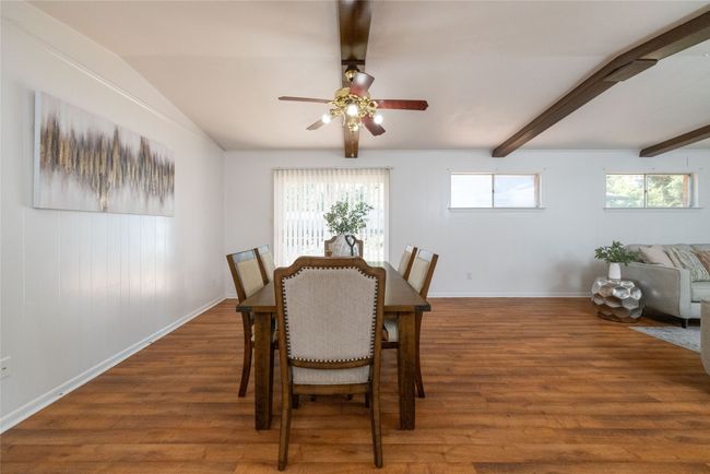 Dining room featuring beamed ceiling, wood finished floors, ceiling fan, and baseboards | Image 5
