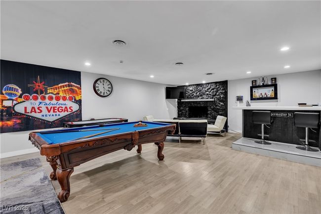 Recreation room with recessed lighting, billiards, a stone fireplace, and wood finished floors | Image 17