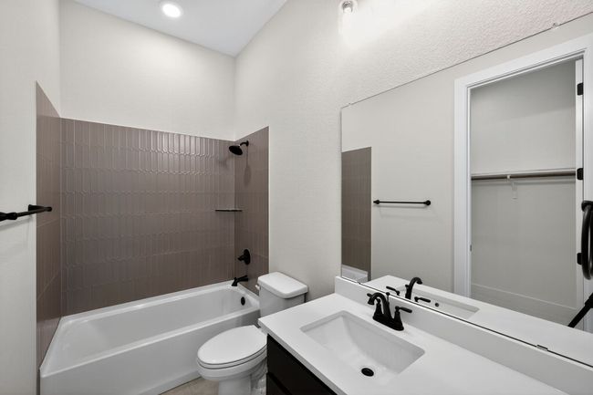 Full bathroom featuring shower / tub combination, vanity, and a spacious closet | Image 18