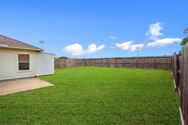 Nice spacious fenced in back yard with a patio area. | Image 21