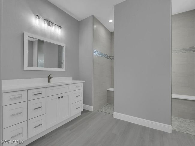 Bathroom with walk in shower, vanity, wood finished floors, and recessed lighting | Image 20