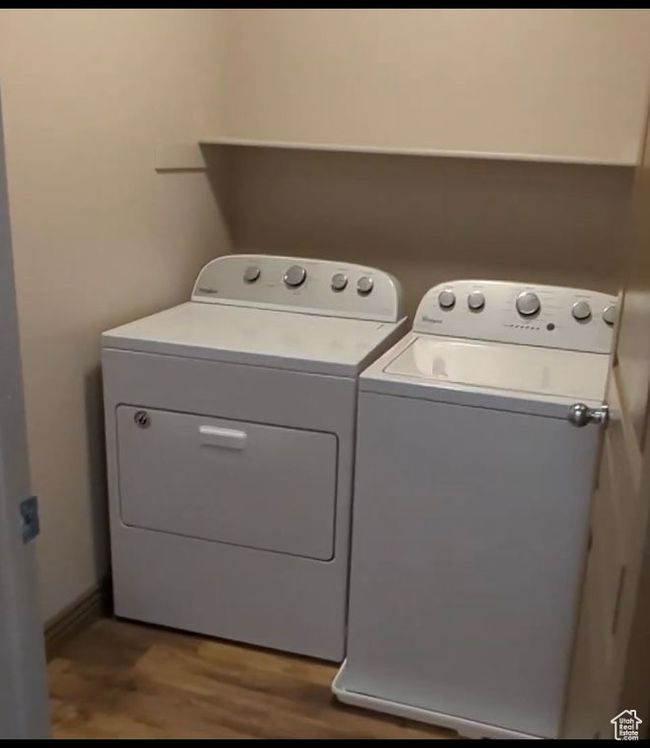Laundry room with washing machine and clothes dryer and wood finished floors | Image 63