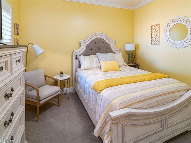 Carpeted bedroom featuring crown molding | Image 12