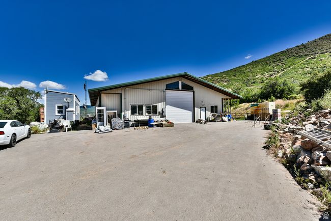View of side of property with a garage, an outbuilding, and a mountain view | Image 48