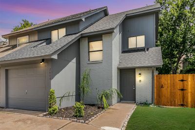 View of front of property featuring a garage and a lawn | Image 1