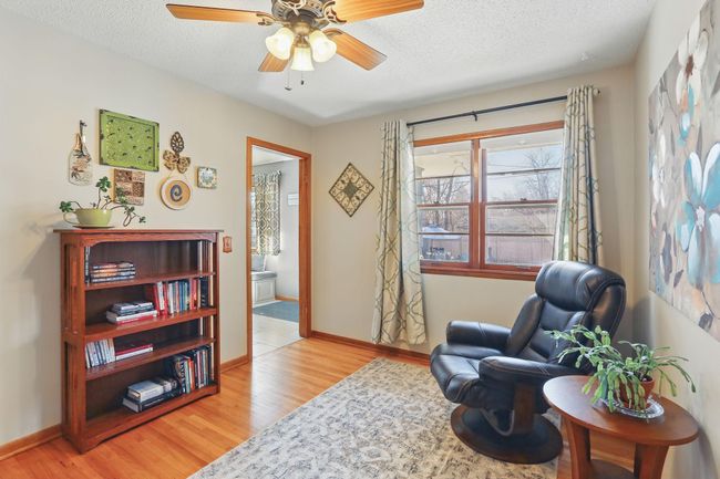 Traditional 1950's walk-through bedroom is currently being used as a sitting room. A perfect space for a home office or a larger dining area. | Image 12