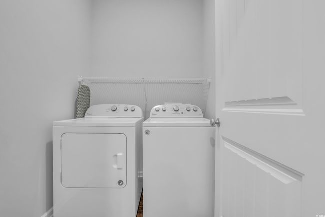 Laundry room with washer and clothes dryer and laundry area | Image 26