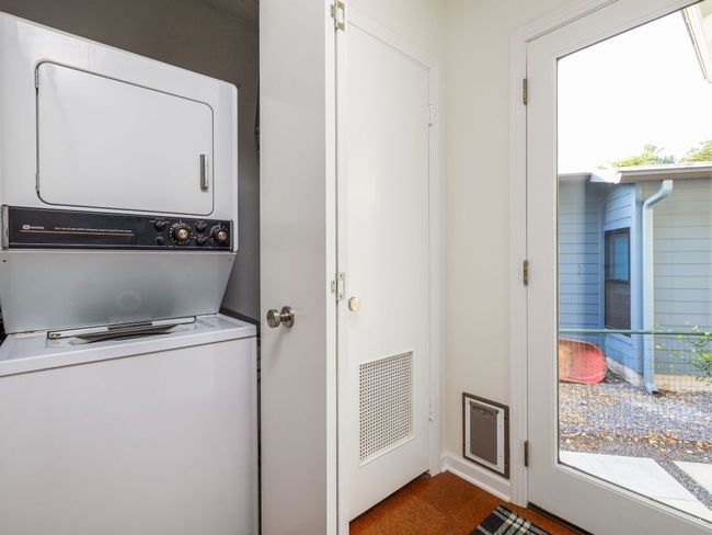 Laundry area with stacked washer and clothes dryer. | Image 24