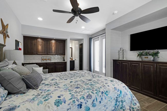 Bedroom with dark wood-style floors, ceiling fan, and recessed lighting | Image 17