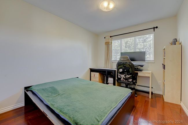Bedroom featuring baseboards, wood finished floors, and a baseboard radiator | Image 11