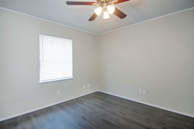 Unfurnished room with dark hardwood / wood-style floors, a wealth of natural light, and ceiling fan | Image 24
