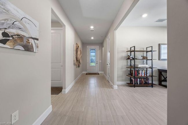 Hallway featuring light wood-style flooring, recessed lighting, baseboards, and visible vents | Image 6